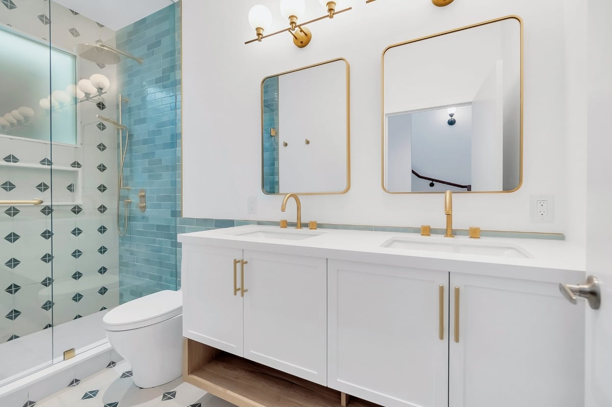 Gold accents in white bathroom renovation condo in Toronto