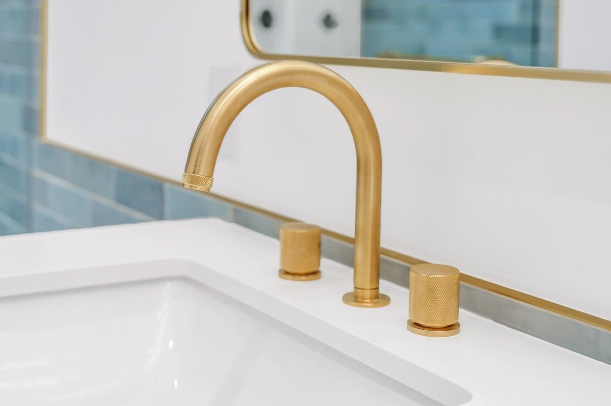 gold faucets in bathroom renovation condo in toronto