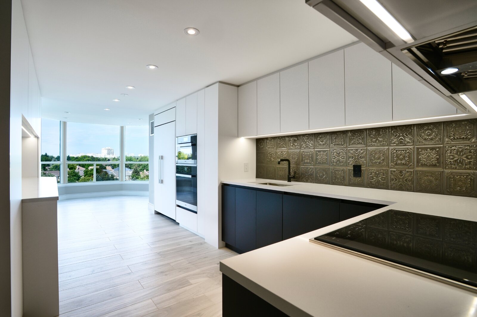 white minimal handless cabinets kitchen condo renovation in toronto